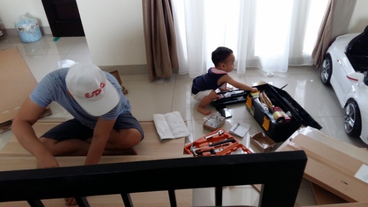 15 months old - Helping out in assembling Ikea. Learning how to screw and unscrew.